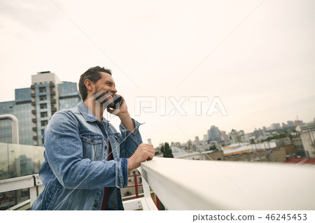 Happy man is holding smartphone in hand Happy man is holding smartphone in hand 46245453