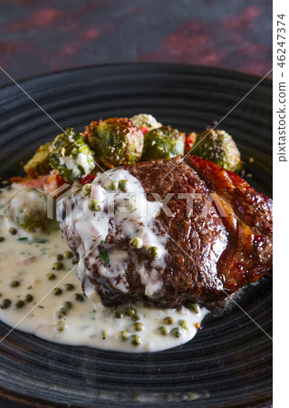 Beefsteak with Brussels sprouts and pea sauce Beefsteak with Brussels sprouts and pea sauce 46247374