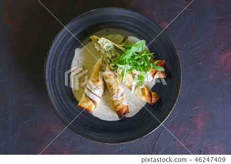 Thin pancakes stuffed with arugula and cheese Thin pancakes stuffed with arugula and cheese 46247409