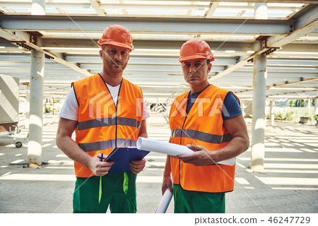 Professional builders in helmets are locating at work 46247729