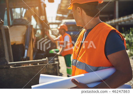 Employees of construction company are working outdoor Employees of construction company are working outdoor 46247863