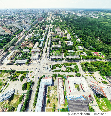 Aerial city view with crossroads and roads, houses, buildings, parks and parking lots. Sunny summer Aerial city view with crossroads and roads, houses, buildings, parks and parking lots. Sunny summer 46248432