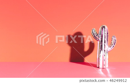 Creative golden cactus on Living Coral background. Creative golden cactus on Living Coral background. 46249912