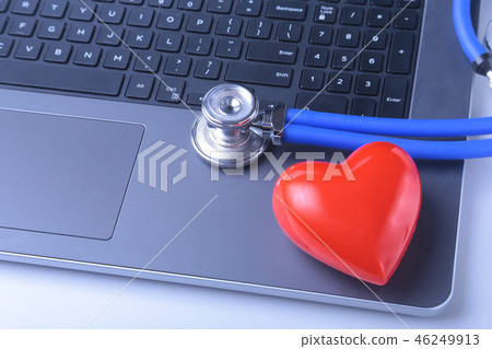 Workplace of doctor with laptop, stethoscope, red heart and notebook on white table. top view. Workplace of doctor with laptop, stethoscope, red heart and notebook on white table. top view. 46249913