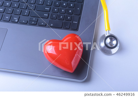 Workplace of doctor with laptop, stethoscope, red heart and notebook on white table. top view. Workplace of doctor with laptop, stethoscope, red heart and notebook on white table. top view. 46249916