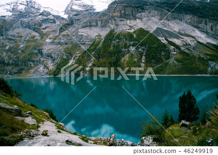 View of Oeschinen Lake in the Swiss alps with beautiful turquoise water. View of Oeschinen Lake in the Swiss alps with beautiful turquoise water. 46249919