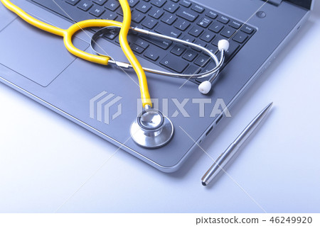 Workplace of doctor with laptop, stethoscope and RX prescription on white table. top view. Workplace of doctor with laptop, stethoscope and RX prescription on white table. top view. 46249920