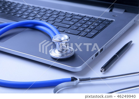 Workplace of doctor with laptop, stethoscope and RX prescription on white table. top view. Workplace of doctor with laptop, stethoscope and RX prescription on white table. top view. 46249940