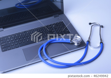 Workplace of doctor with laptop, stethoscope and RX prescription on white table. top view. Workplace of doctor with laptop, stethoscope and RX prescription on white table. top view. 46249942