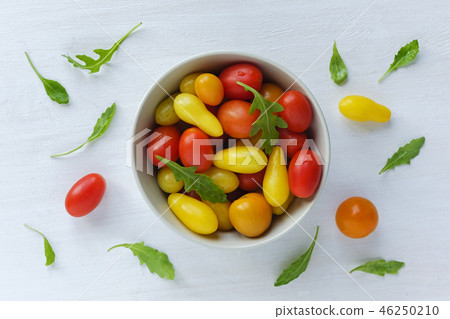 Bowl of red and yellow tomatoes Bowl of red and yellow tomatoes 46250210