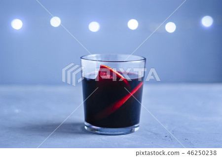 Glass of red beverage with citrus slices Glass of red beverage with citrus slices 46250238