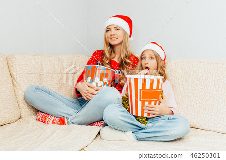 Mom and her little daughter, dressed in Santa  46250301