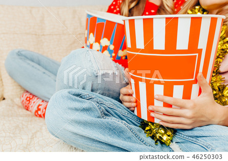 Close-up, in the hands of a bucket of popcorn 46250303