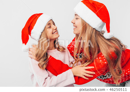 Mom and daughter are wearing Santa Claus hats Mom and daughter are wearing Santa Claus hats 46250511