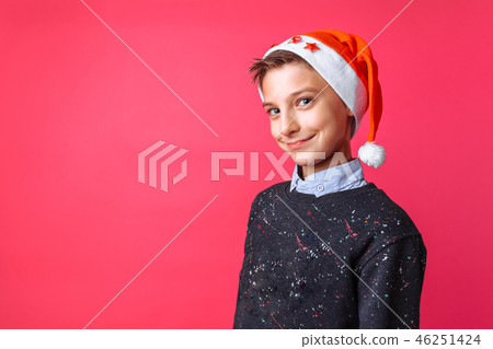 Positive teen in Santa hat, guy smiling Positive teen in Santa hat, guy smiling 46251424