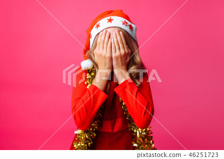 teen in Santa's red hat and with tinsel teen in Santa's red hat and with tinsel 46251723