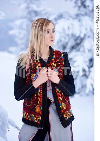 Young attractive woman in white fur coat. Traditional women's attire of western part of Ukraine. 46251866