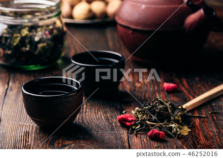 Tea bowls and spoonful of raspberry herbal tea 46252016