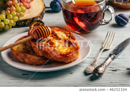 French toasts with honey, fruits and tea French toasts with honey, fruits and tea 46252104