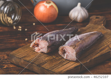 Hake carcasses on cutting board 46252107