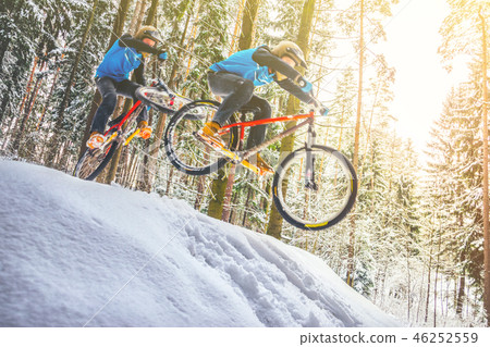 Mountain biking in snowy forest Mountain biking in snowy forest 46252559