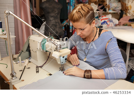 Young female blonde dressmaker cloth designer 46253334