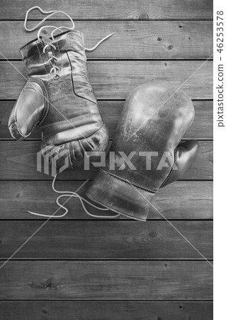 Old boxing gloves on the wooden surface with copy space for text. High resolution 3D rendering 46253578