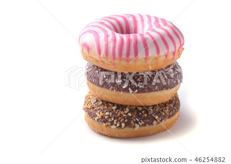 Assorted doughnuts in the glaze, colorful sprinkles and nuts on a white background. 46254882