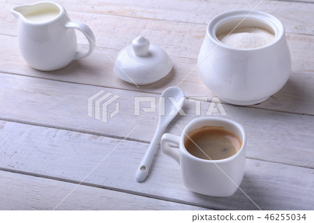 Cup of hot coffee espresso, coffee beans, jug of milk, and bowl with sugar on white background for 46255034
