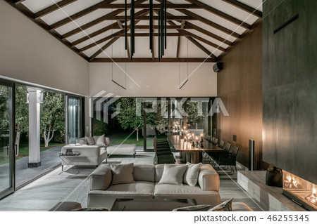 Illuminated interior with wooden beams and fireplace 46255345