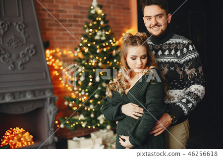 Cute family standing near Christmas tree 46256618