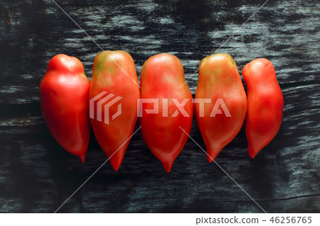 Tomatoes on a wooden surface 46256765