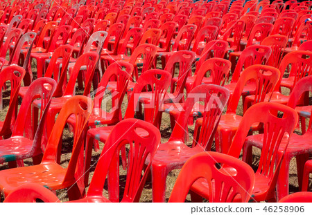 Group of red plastic chairs 46258906