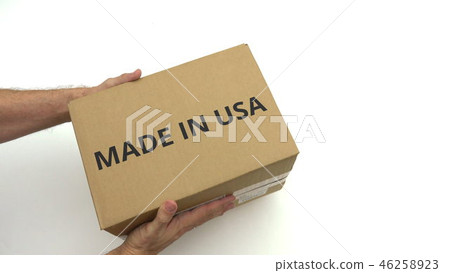 Man delivers carton with MADE IN USA text on it Man delivers carton with MADE IN USA text on it 46258923