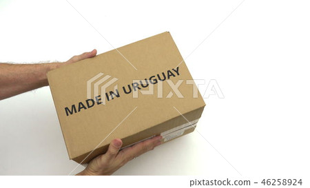 Man holds carton with MADE IN URUGUAY text Man holds carton with MADE IN URUGUAY text 46258924