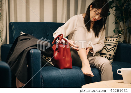 Young Japanese woman going home and doing foot massage in the room 46261681