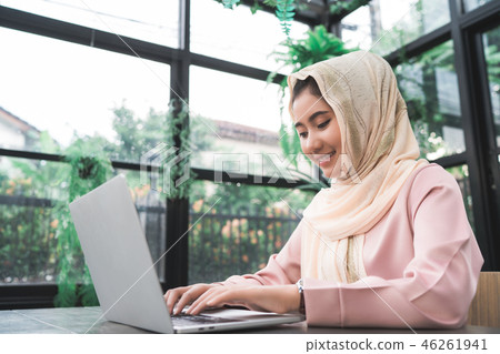 woman working on laptop sitting at home.  46261941