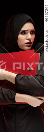 Portrait of beautiful desperate scared frightened young muslim woman wearing black hijab holding Portrait of beautiful desperate scared frightened young muslim woman wearing black hijab holding 46267265
