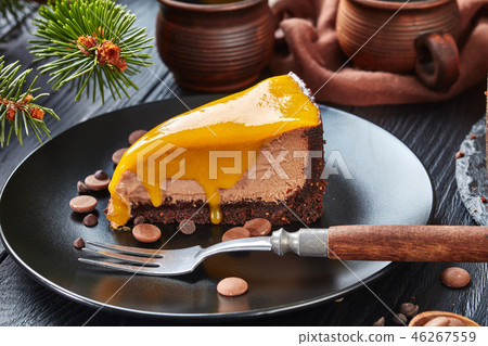 a piece of a chocolate mango cheesecake 46267559