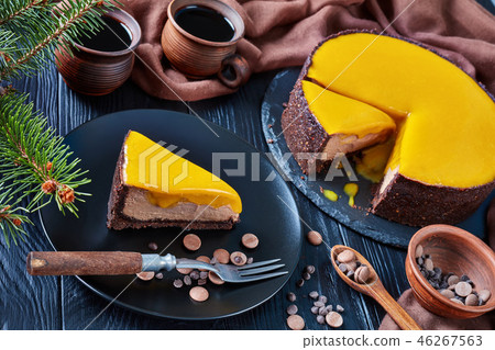 a piece of a chocolate mango cheesecake a piece of a chocolate mango cheesecake 46267563
