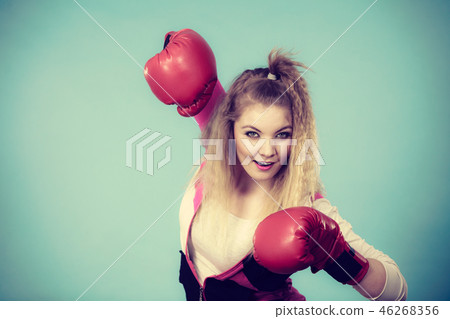 Funny girl in red gloves playing sports boxing 46268356