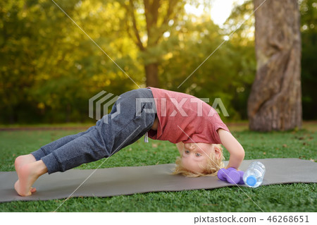 Little boy doing stretch during workout outdoors 46268651