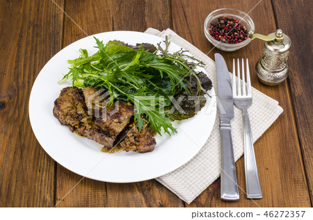 Slices of fried liver, green leaves of salads Slices of fried liver, green leaves of salads 46272357