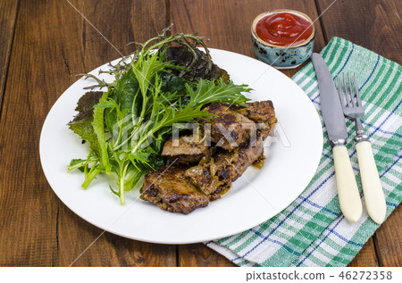 Slices of fried liver, green leaves of salads 46272358