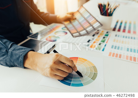 Young people holding pen pointing at color sheet 46272498