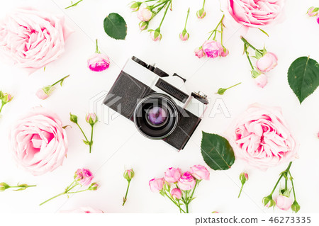 Pink rose flowers with old retro camera on white Pink rose flowers with old retro camera on white 46273335