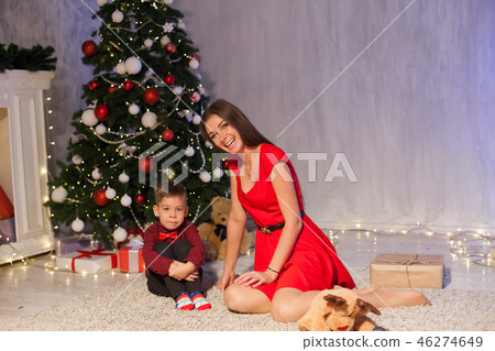 mother and little boy open Gifts Christmas tree new year 46274649