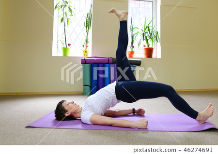 Beautiful girl doing stretching exercises and yoga asanas. Beautiful girl doing stretching exercises and yoga asanas. 46274691