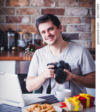 man with camera and laptop in Christmas time man with camera and laptop in Christmas time 46274960