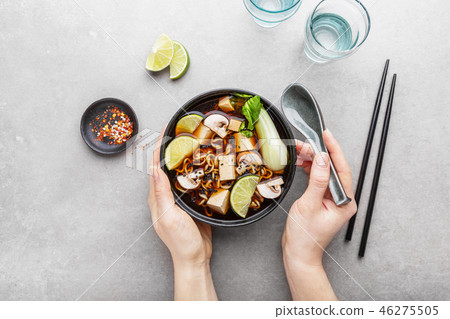 Woman eating tofu asian vegetarian soup in bowl Woman eating tofu asian vegetarian soup in bowl 46275505